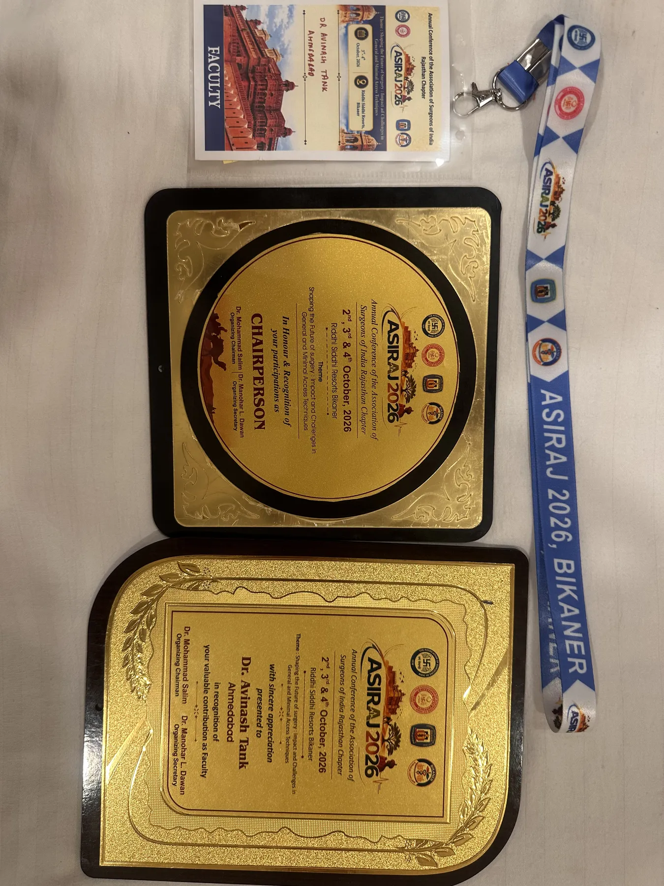 Dr. Avinash Tank's ASIRAJ 2026 faculty badge with the Faculty and Chairperson plaques