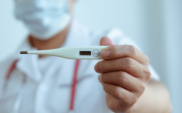 A doctor holding a thermometer indicating fever