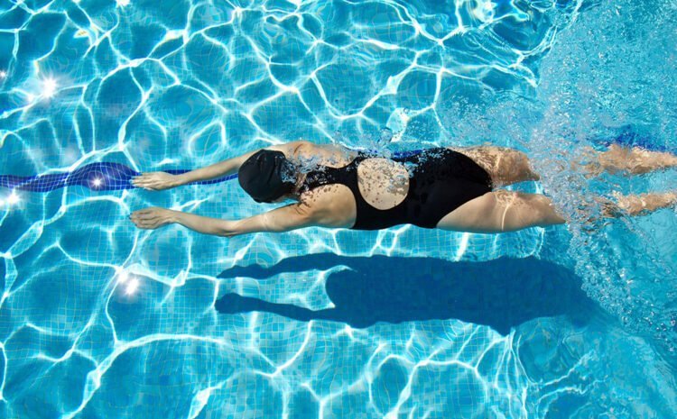 a woman swimming in a pool